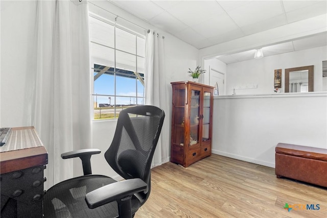 office space with light wood-type flooring and baseboards