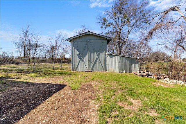 view of outbuilding featuring an outbuilding and fence