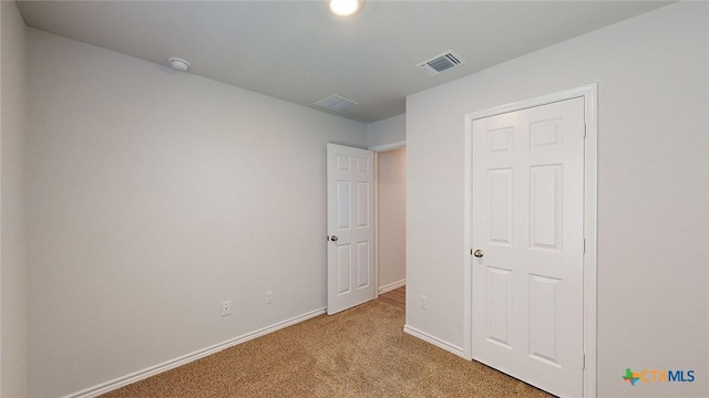 unfurnished bedroom featuring light colored carpet