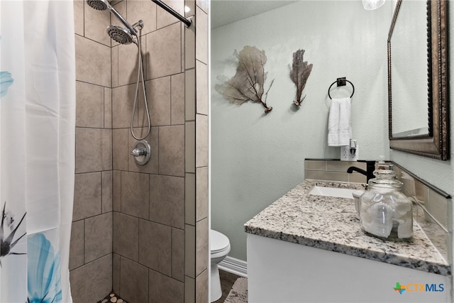 bathroom with a shower with shower curtain, toilet, and vanity