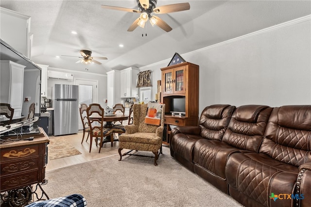 living room with light hardwood / wood-style floors, lofted ceiling, ornamental molding, ceiling fan, and an AC wall unit