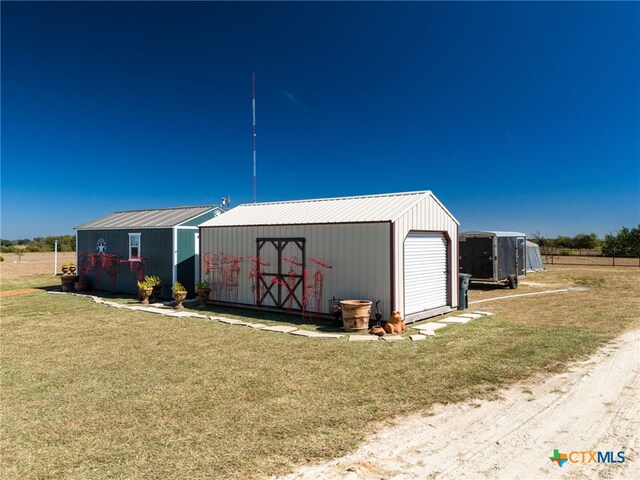 view of outbuilding with a garage and a lawn