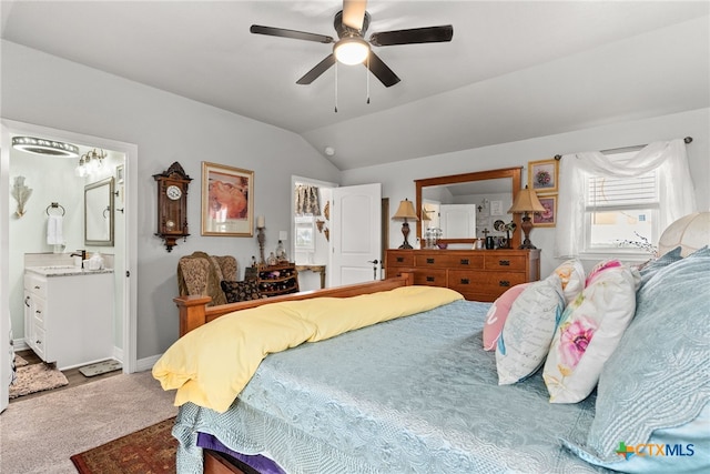 carpeted bedroom with lofted ceiling, ceiling fan, and ensuite bathroom