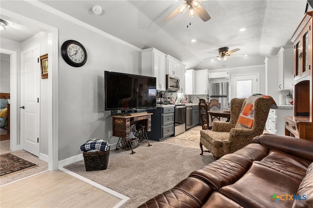 living room with ornamental molding, light hardwood / wood-style flooring, ceiling fan, and vaulted ceiling