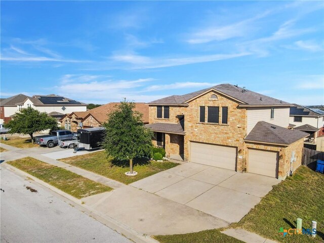 view of front of house with a front lawn and a garage