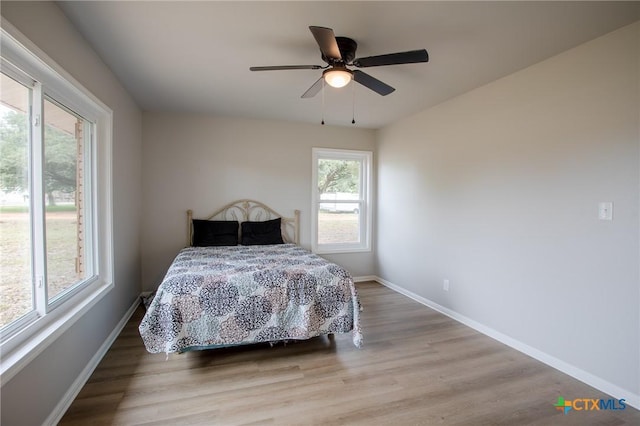 bedroom featuring ceiling fan and light hardwood / wood-style floors