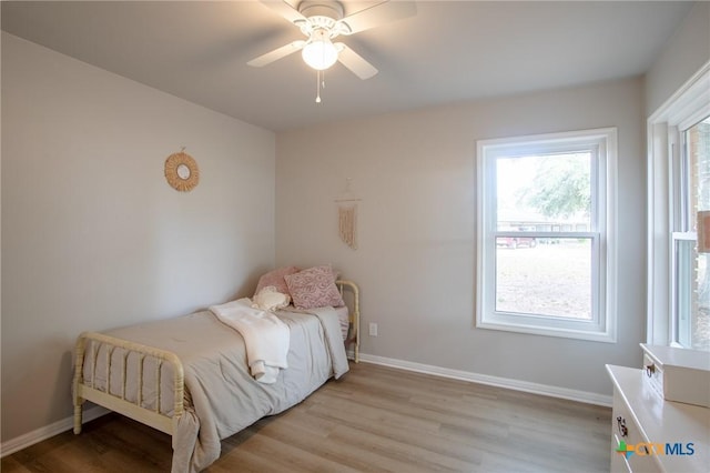 bedroom with light wood-type flooring and ceiling fan