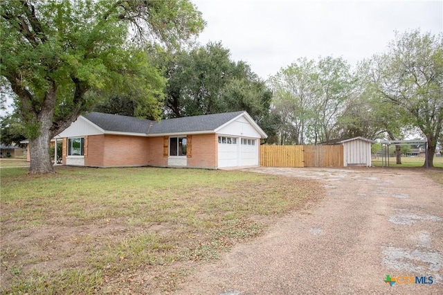 single story home with a garage and a front lawn