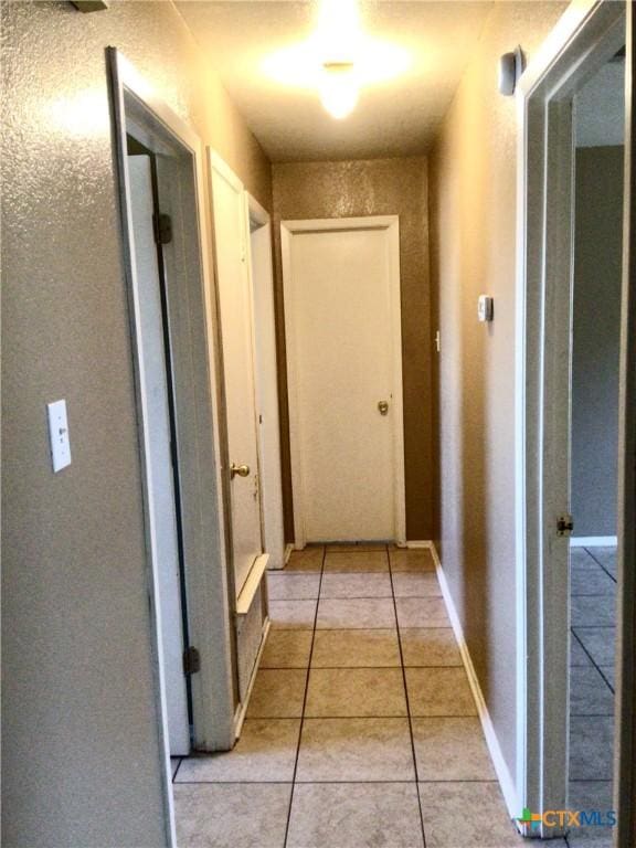 hall with light tile patterned flooring