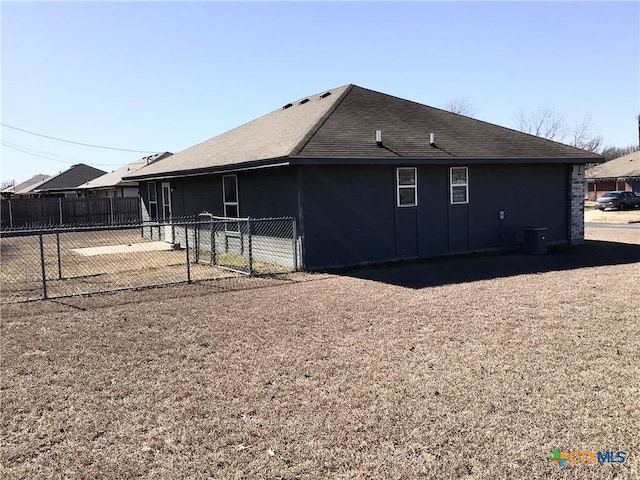 back of house with central AC and a patio