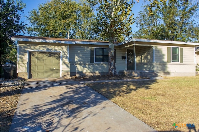 ranch-style house featuring a garage and a front yard