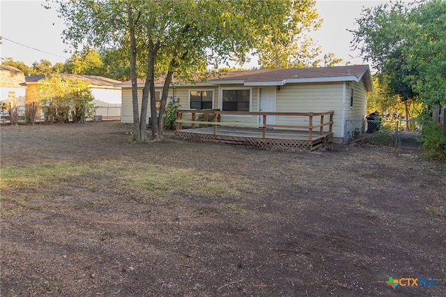 back of house featuring a deck