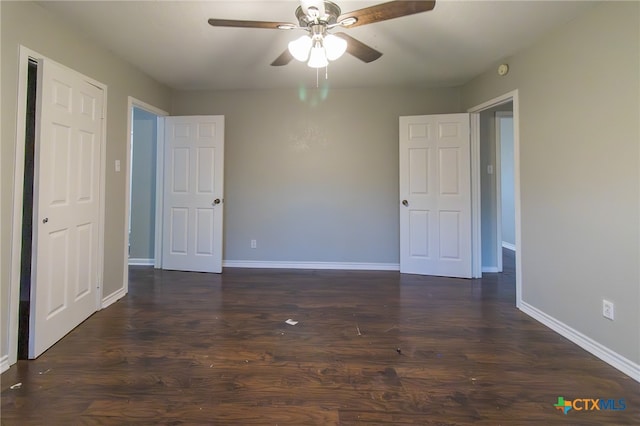 unfurnished bedroom featuring dark hardwood / wood-style flooring and ceiling fan