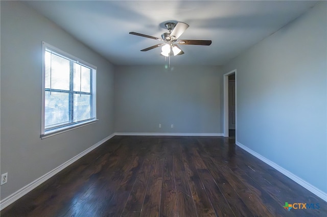 empty room with dark hardwood / wood-style flooring and ceiling fan