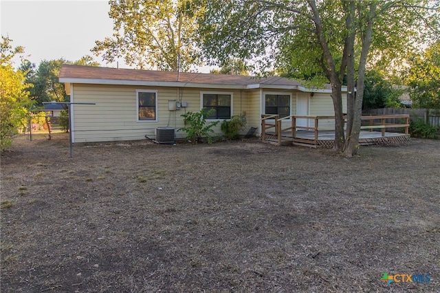 view of front of home with central air condition unit and a wooden deck