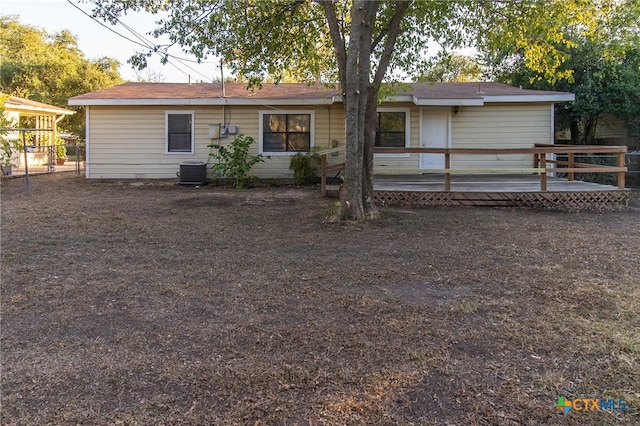 back of house with a wooden deck and cooling unit