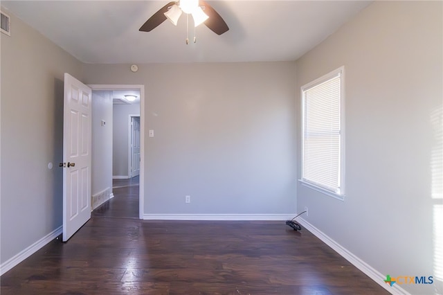 spare room featuring ceiling fan and dark hardwood / wood-style floors