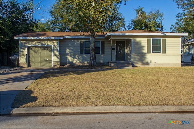 single story home with a garage and a front lawn