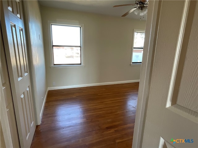 unfurnished room with ceiling fan and dark hardwood / wood-style floors