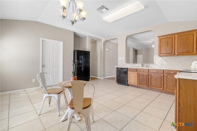 kitchen featuring black appliances, light tile patterned flooring, visible vents, and vaulted ceiling