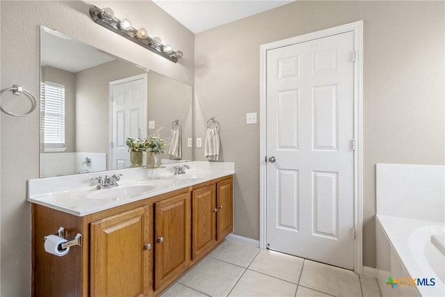 bathroom featuring tile patterned floors, double vanity, a bathing tub, and a sink