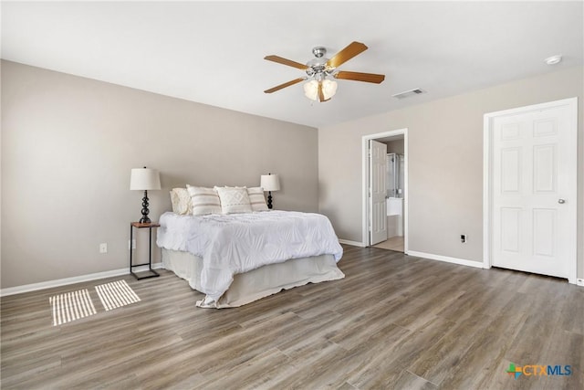 bedroom with visible vents, a ceiling fan, baseboards, and wood finished floors