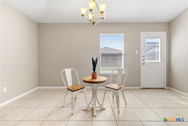 dining space featuring light tile patterned flooring, baseboards, and a chandelier