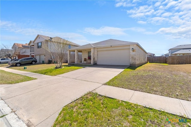 view of front of property with driveway, a front lawn, stone siding, fence, and a garage