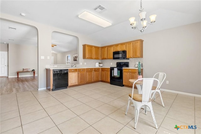 kitchen with visible vents, light tile patterned flooring, black appliances, light countertops, and vaulted ceiling