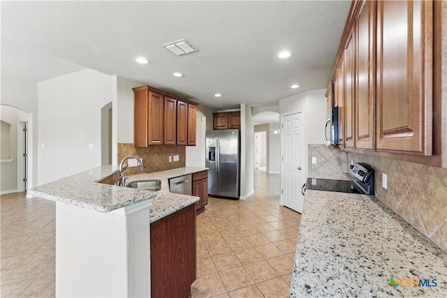 2441 Ibis Ave, New Braunfels, TX 78130 - kitchen with a peninsula, light tile patterned flooring, visible vents, appliances with stainless steel finishes, and arched walkways