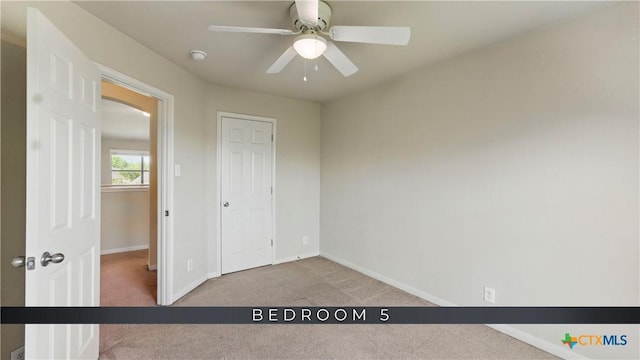 2441 Ibis Ave, New Braunfels, TX 78130 - unfurnished bedroom featuring carpet flooring, baseboards, and ceiling fan