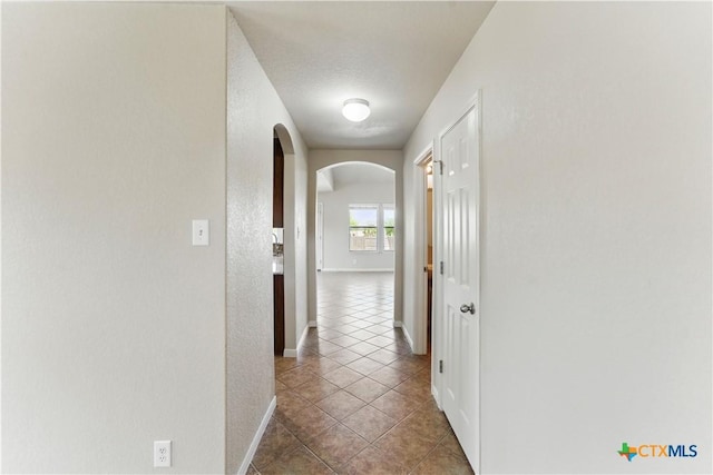 2441 Ibis Ave, New Braunfels, TX 78130 - hall with tile patterned floors, arched walkways, and baseboards