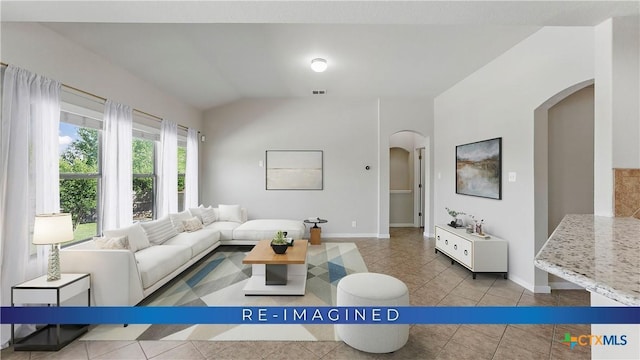 2441 Ibis Ave, New Braunfels, TX 78130 - living room featuring arched walkways, baseboards, tile patterned flooring, and lofted ceiling