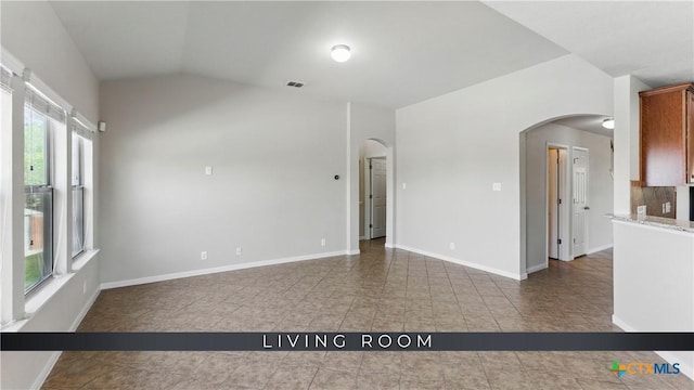 2441 Ibis Ave, New Braunfels, TX 78130 - spare room with arched walkways, tile patterned flooring, and plenty of natural light