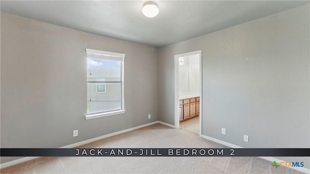 2441 Ibis Ave, New Braunfels, TX 78130 - unfurnished bedroom featuring light carpet, ensuite bathroom, and baseboards