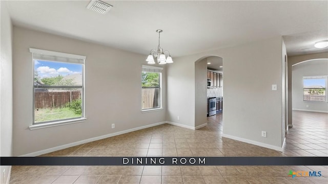 2441 Ibis Ave, New Braunfels, TX 78130 - unfurnished dining area with tile patterned floors, plenty of natural light, visible vents, and arched walkways