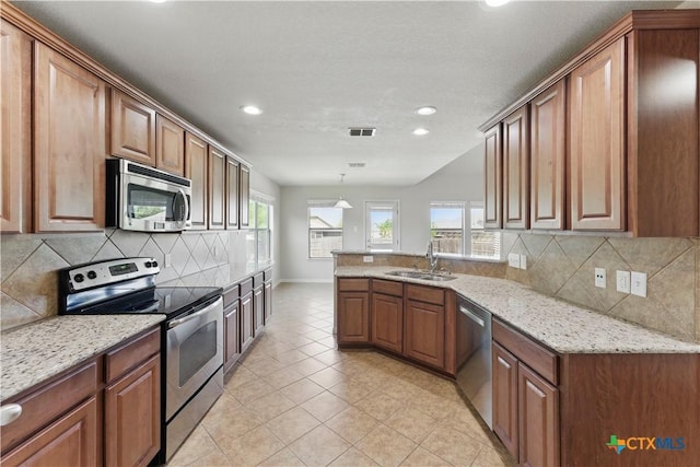 2441 Ibis Ave, New Braunfels, TX 78130 - kitchen featuring visible vents, a sink, appliances with stainless steel finishes, brown cabinetry, and recessed lighting