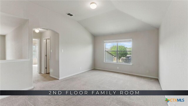 2441 Ibis Ave, New Braunfels, TX 78130 - unfurnished room featuring visible vents, baseboards, arched walkways, carpet floors, and vaulted ceiling