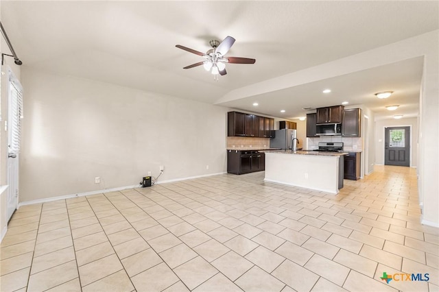 10055 Strasbourg Way, Schertz, TX 78154 - kitchen with stainless steel appliances, open floor plan, dark brown cabinets, ceiling fan, and backsplash