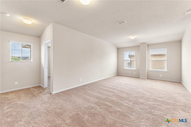 10055 Strasbourg Way, Schertz, TX 78154 - spare room with light carpet, a textured ceiling, healthy amount of natural light, and a smoke detector