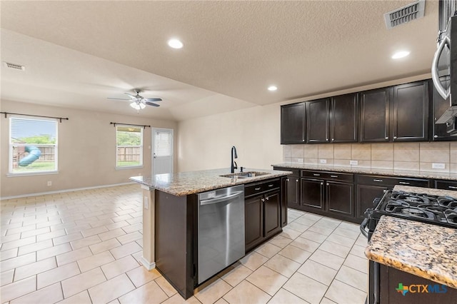 10055 Strasbourg Way, Schertz, TX 78154 - kitchen with stainless steel dishwasher, ceiling fan, backsplash, a center island with sink, and open floor plan