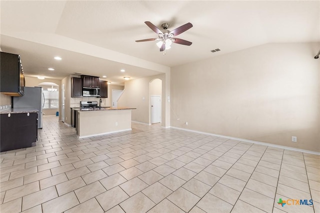 10055 Strasbourg Way, Schertz, TX 78154 - unfurnished living room with arched walkways, ceiling fan, lofted ceiling, recessed lighting, and light tile patterned floors