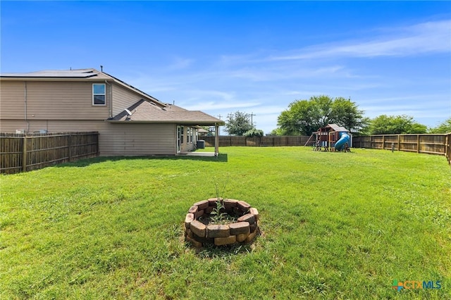 10055 Strasbourg Way, Schertz, TX 78154 - fenced backyard featuring an outdoor fire pit and a playground