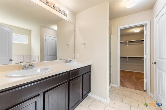 10055 Strasbourg Way, Schertz, TX 78154 - bathroom featuring a stall shower, double vanity, tile patterned floors, and a spacious closet