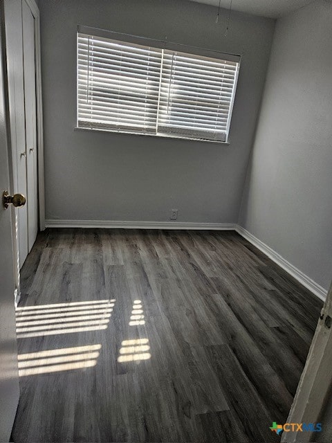 unfurnished room featuring dark hardwood / wood-style flooring