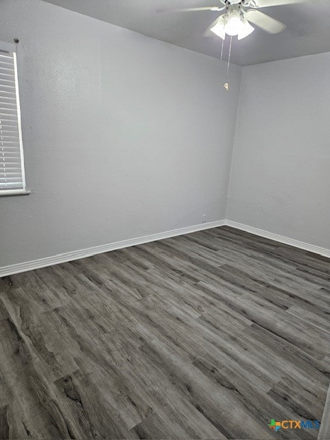 spare room featuring dark hardwood / wood-style floors and ceiling fan