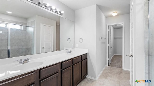 7350 Braes Cor, San Antonio, TX 78244 - full bathroom with double vanity, a stall shower, a spacious closet, and tile patterned floors