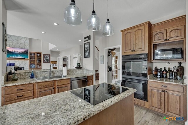 448 Summer Glen Ln, New Braunfels, TX 78132 - kitchen with black appliances, a sink, light stone counters, brown cabinetry, and hanging light fixtures
