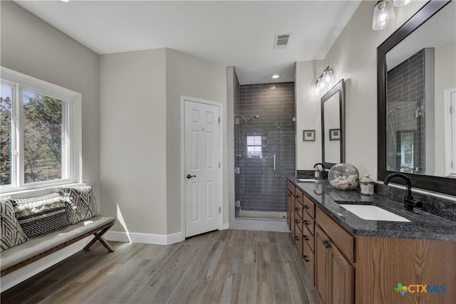 448 Summer Glen Ln, New Braunfels, TX 78132 - bathroom with a stall shower, wood finished floors, double vanity, baseboards, and recessed lighting