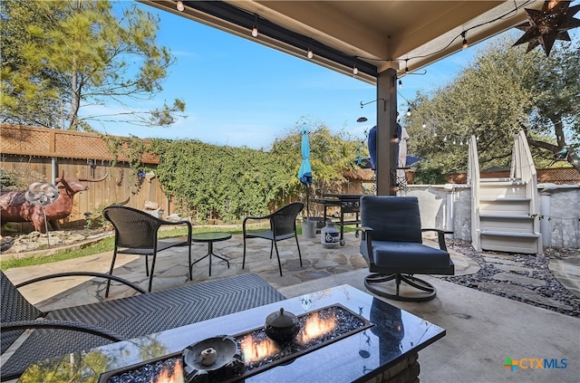 view of patio / terrace featuring a fire pit